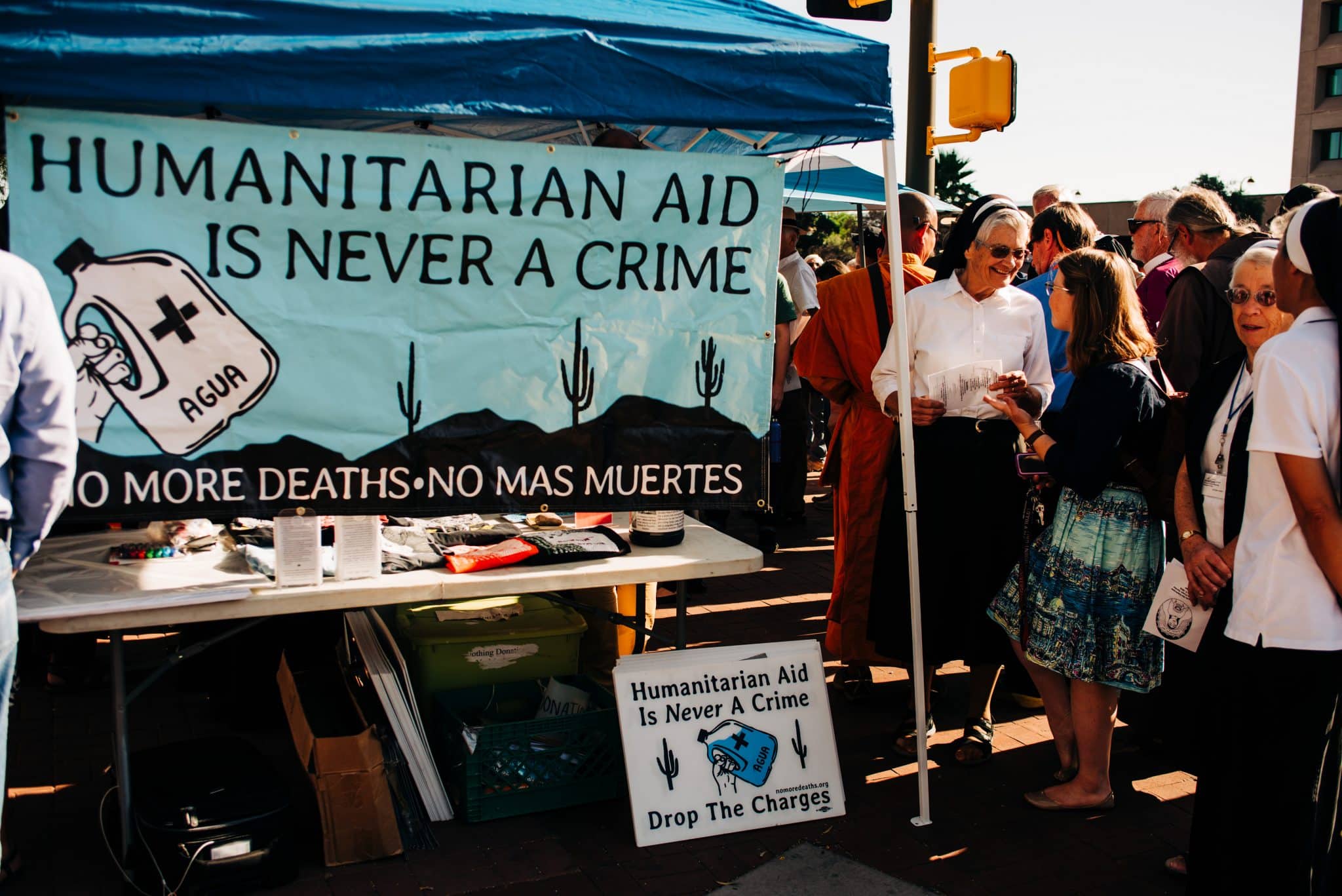 nuns standing by a tent a at an outdoor gathering 