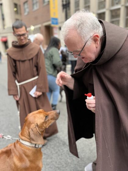St. Anthony Shrine petting dogs on the street