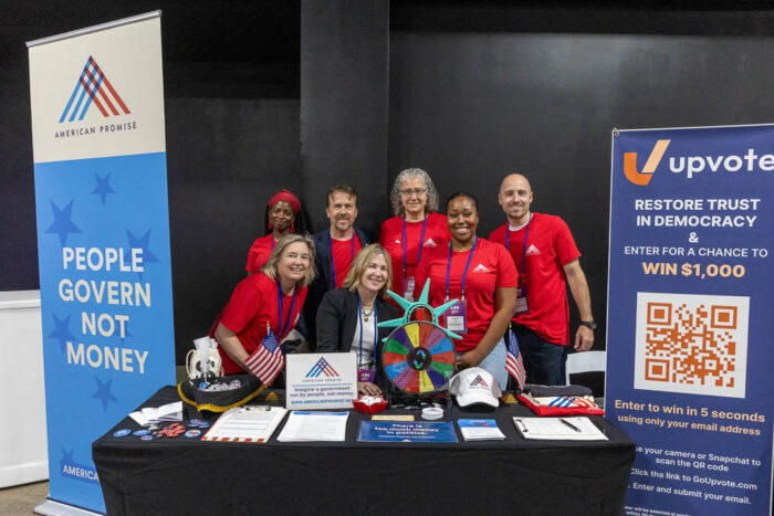 American Promise booth with volunteers behind the table