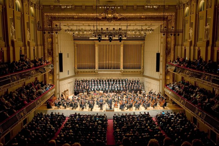 concert hall with an orchestra perfomring on stage
