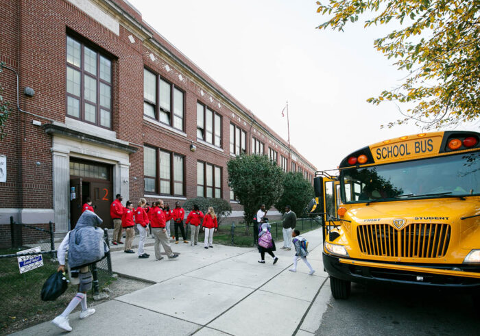 city year volunteers coming out of a school