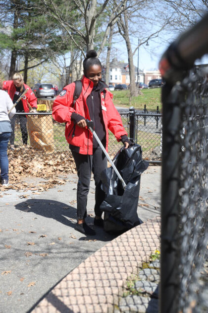 City Year volunteer picking up trash in community