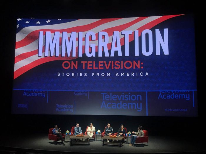 panel of four people seated in front of a screen that reads immigration of television stories from america