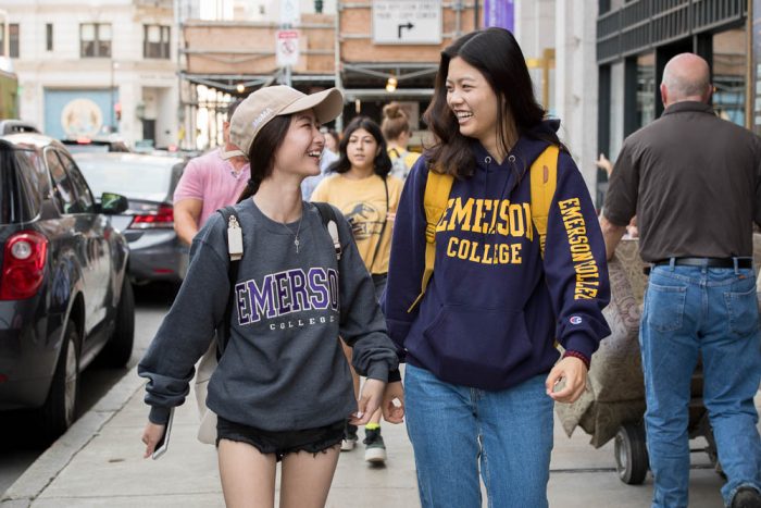 two emerson students walking on a sidewalk