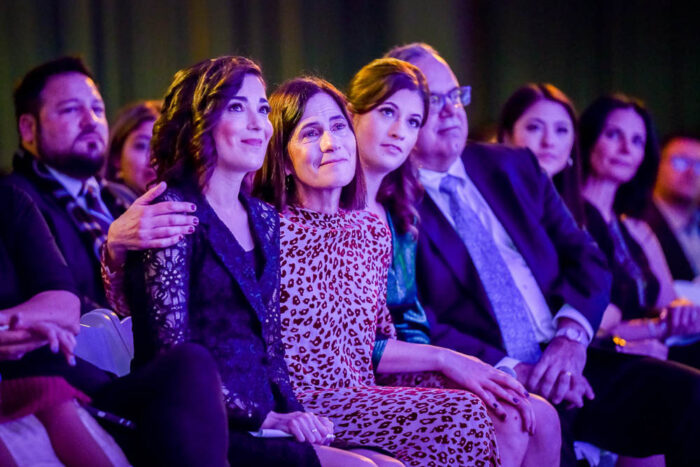 Three women sitting in the audience