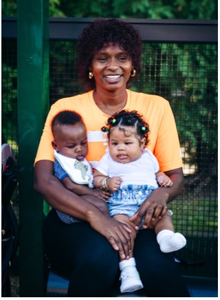 Family photo with a woman and two infants