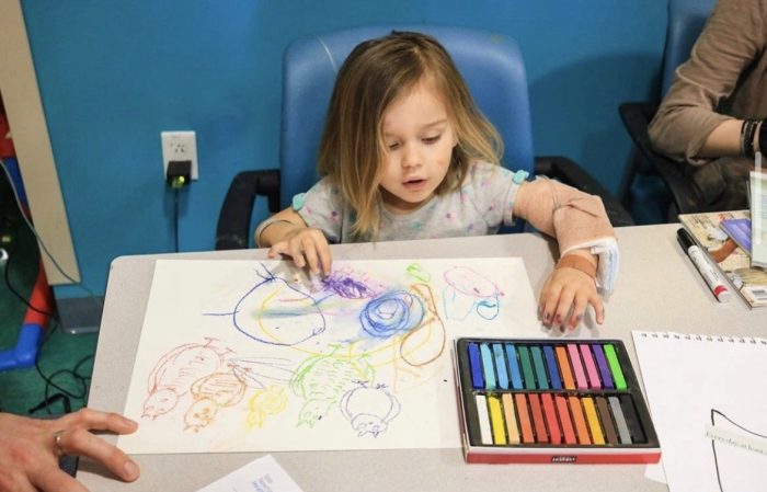 little girl creating a drawing with encourage kids