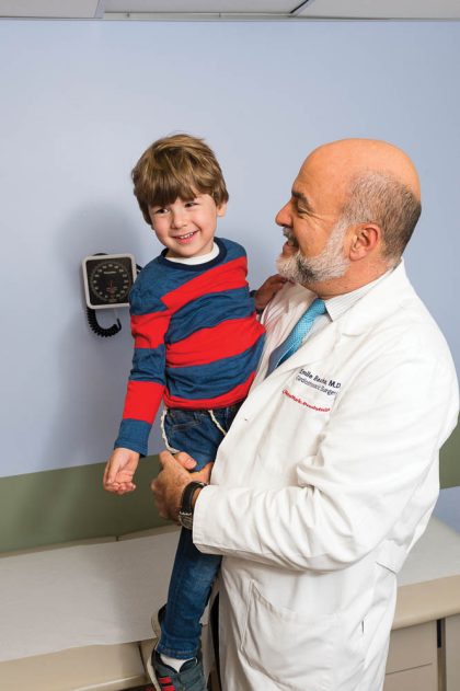 new york presbyterian doctor holding a child