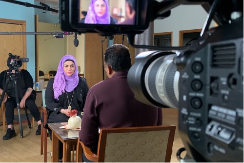 woman wearing hijab being interviewed for a documentary