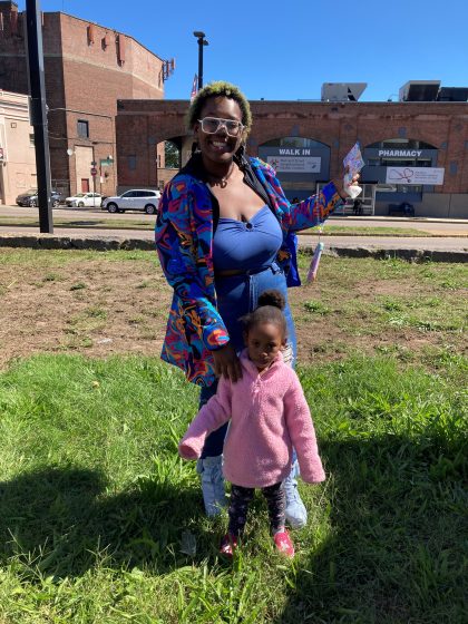woman and child posing in front of a building