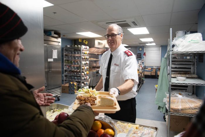 a salvation army volunteer handing out food