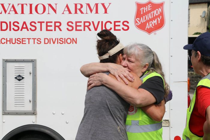 a salvation army volunteer hugging a woman