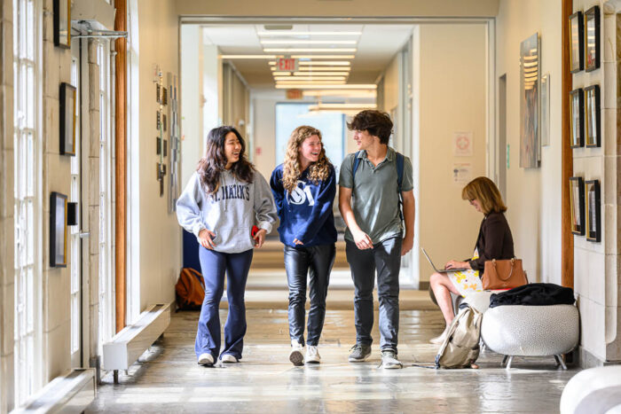three St. Mark's students walking down a hallway
