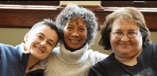three diverse women smiling for the camera