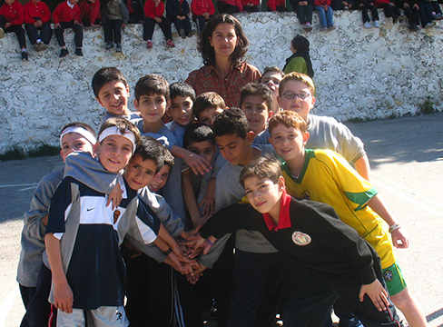 woman posing with a group of children 